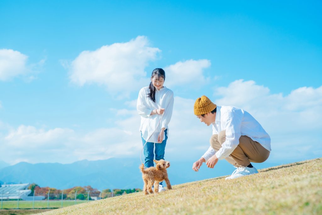 愛犬と遊ぶ男女の様子